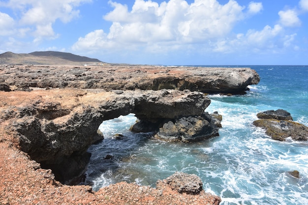 Pretty rock coastline on the shores of blear blue aruban waters