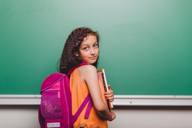 Pretty schoolgirl with books