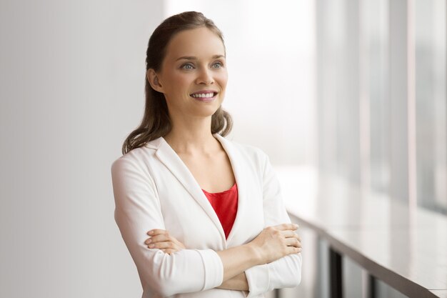 Pretty Smiling Business Woman Standing at Window