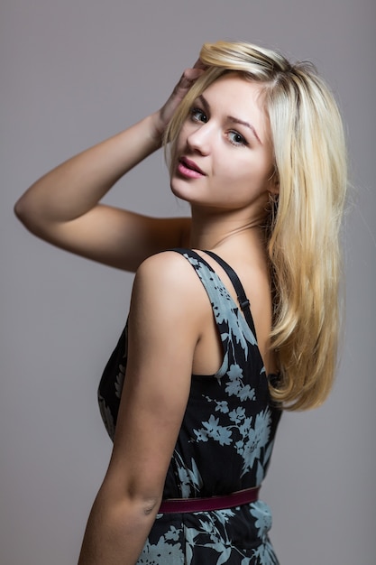 Free photo pretty smiling good-looking beautiful woman isolated against blank studio wall.