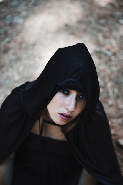 Free photo pretty sorceress in black hood