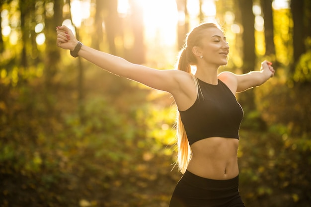 Pretty sport woman doing yoga exercises in the park