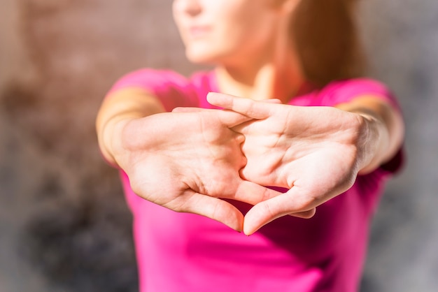 Free Photo pretty sporty young woman stretching clasped hands