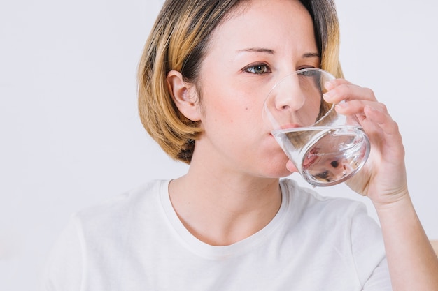 Pretty woman drinking water