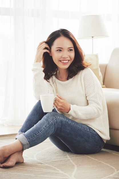 Pretty woman enjoying cup of coffee