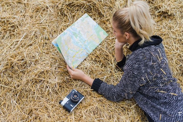 Free Photo pretty woman in hay with map