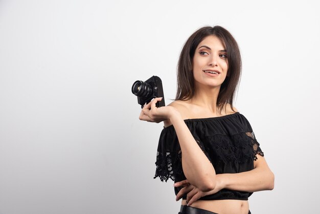 Pretty woman holding camera