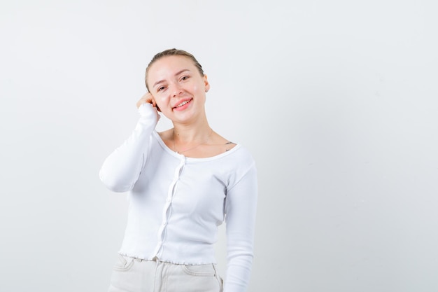 Pretty woman is calling to somebody on phone on white background