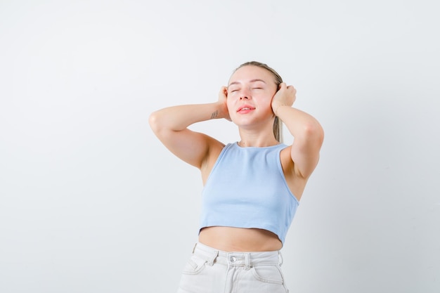 pretty woman is listening to music on white background