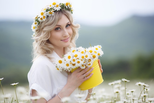 pretty woman portrait in camomile field