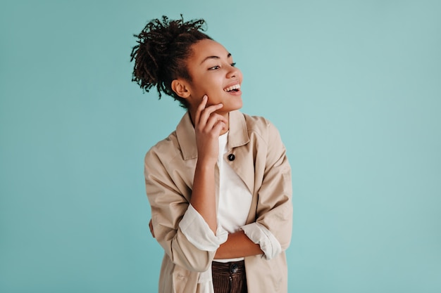 Pretty woman posing in beige trench coat