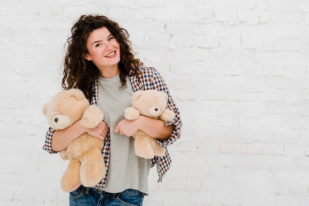 Free photo pretty woman posing with plush toys