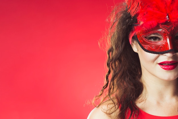 Pretty woman in red carnival mask