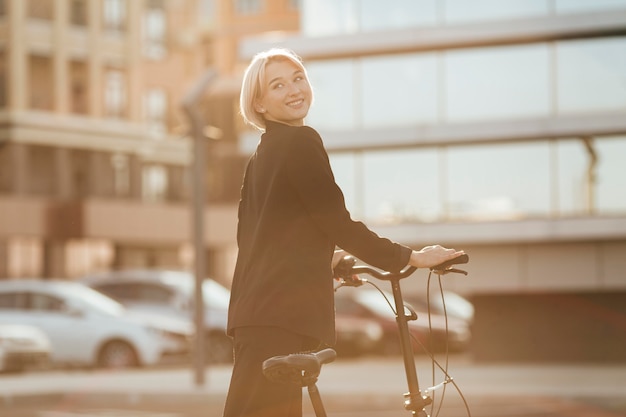 Pretty woman riding her bicycle outdoors