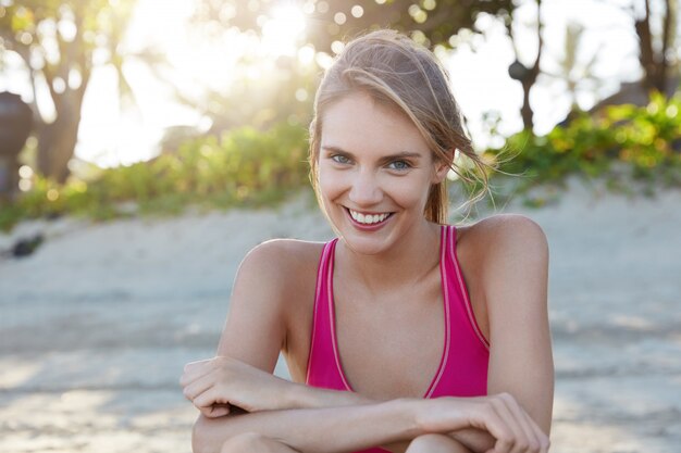 Pretty woman in sportswear on beach