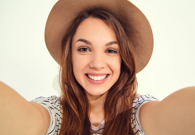 pretty woman in summer hipster clothes take selfie from hands with phone