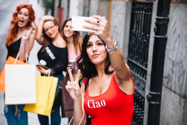 Pretty woman taking selfies with her friends