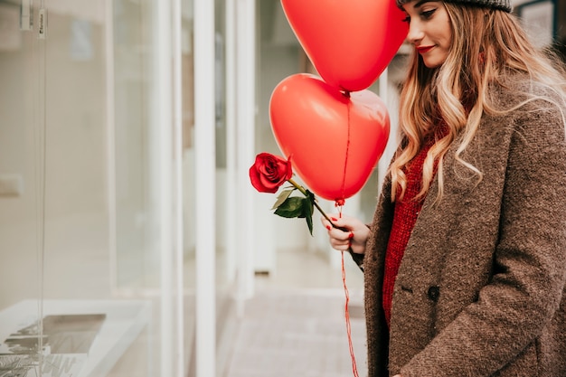 Free Photo pretty woman with balloons and rose