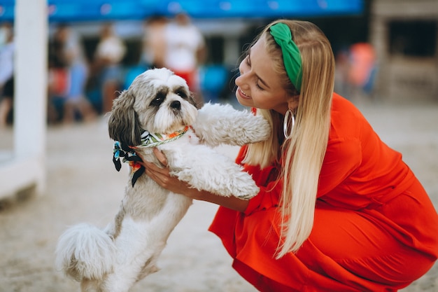 Free photo pretty woman with her cute dog on vacation