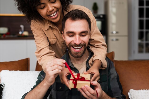 Pretty woman woman offering a  gift to her boyfriend