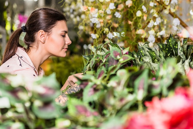 Free photo pretty woman working in green house