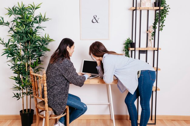 Pretty women working at laptop