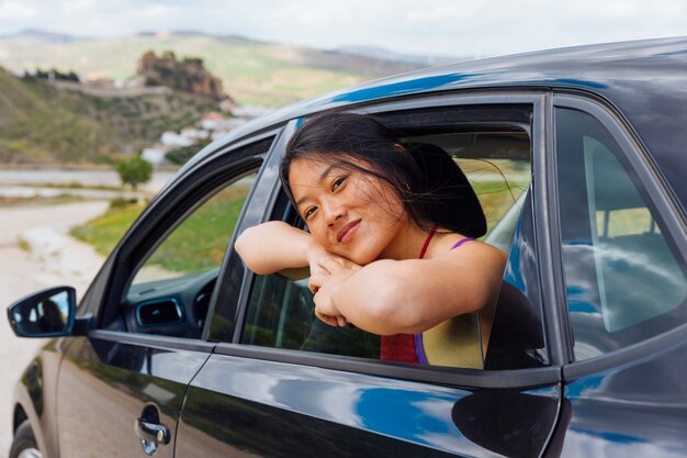 Pretty young ethnic woman sitting in machine