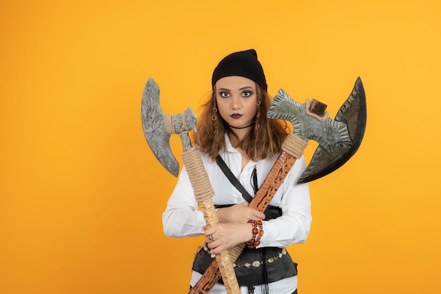 Free Photo pretty young girl holding axes and looking at camera. high quality photo