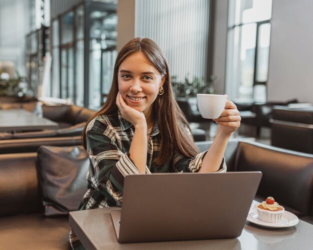 Pretty young woman enjoying a coffee break