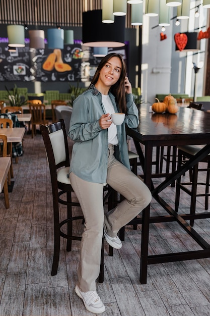 Pretty young woman enjoying a coffee cup