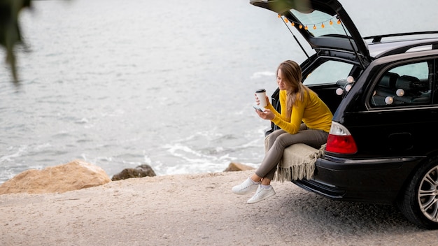 Pretty young woman enjoying road trip