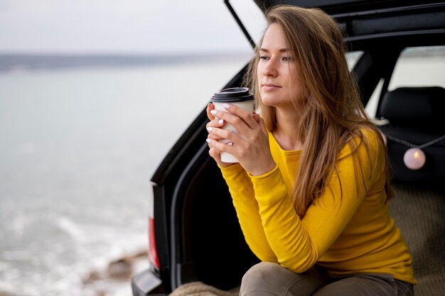 Pretty young woman enjoying road trip