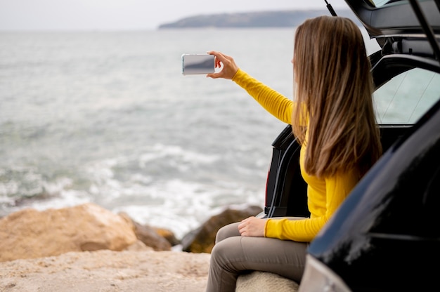 Pretty young woman enjoying road trip