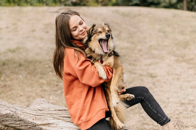 Pretty young woman petting her dog