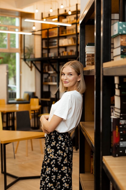 Pretty young woman posing at the library