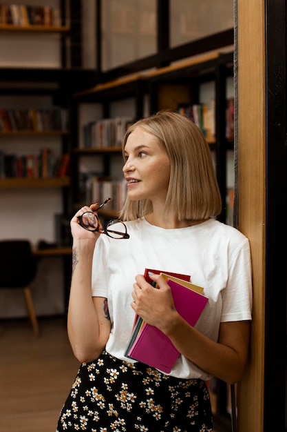 Pretty young woman posing at the library