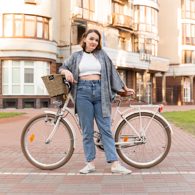 Pretty young woman posing with bike