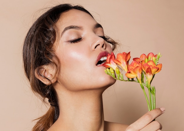 Pretty young woman with vibrant flower