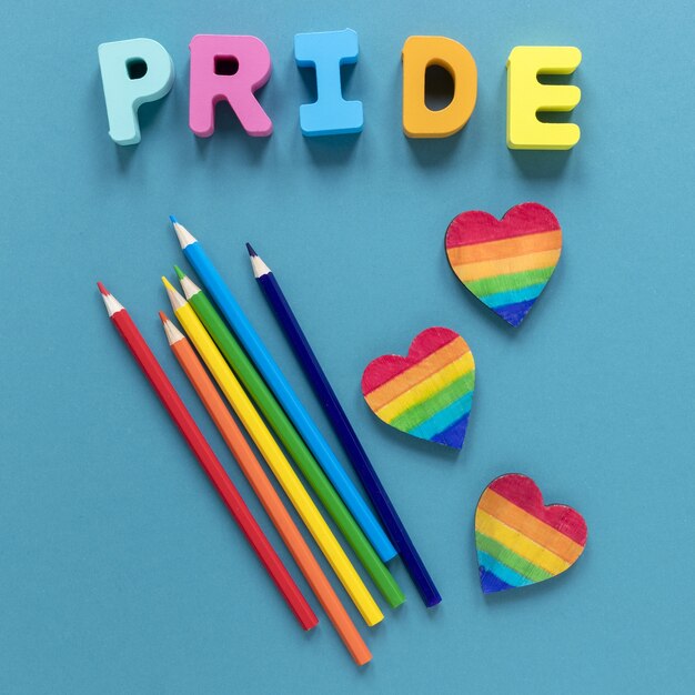 Pride word with crayons and heart shape