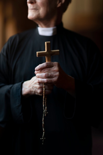 Priest praying in church