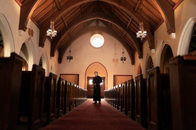 Priest praying in church