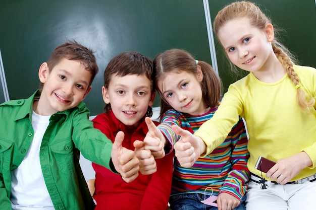 Free photo primary students with thumbs up