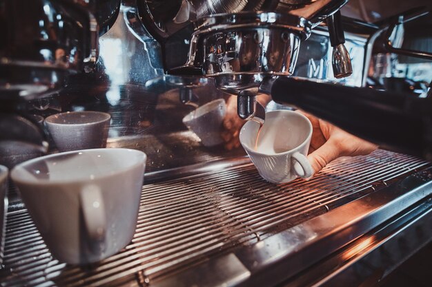 Process of coffee making using coffee machine at restaurant by talanted barista.