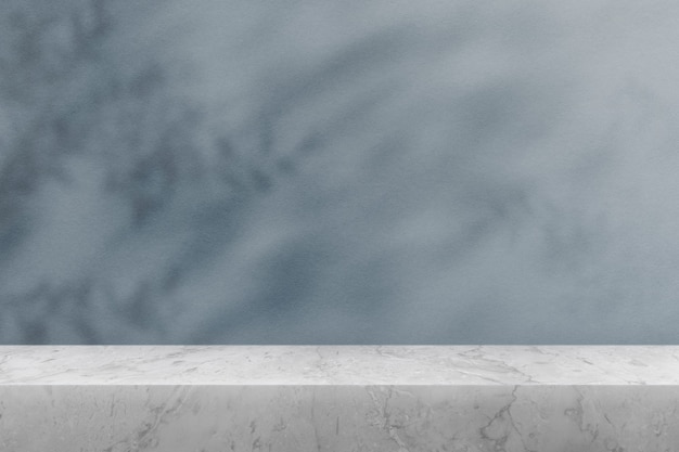 Free photo product backdrop, empty marble table top with blue wall and plant shadow