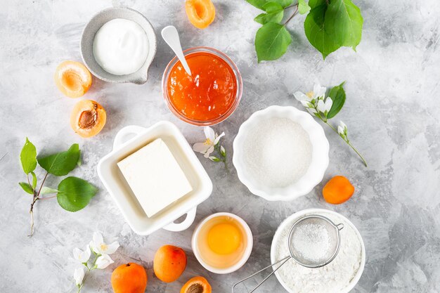 Products for making French biscuits or apricot pie Ingredients for summer baking on a bright table