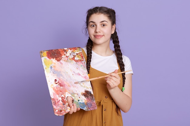 Free Photo professional artist smiling with paint brush and palette