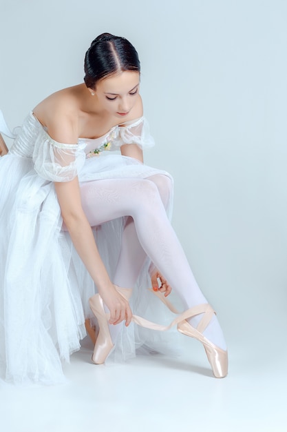 Professional ballerina putting on her ballet shoes