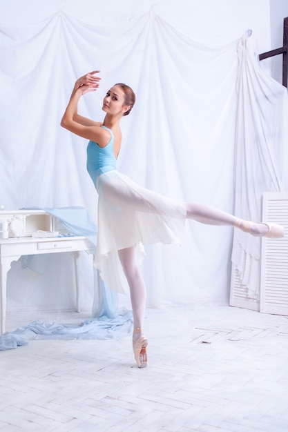 Free photo professional ballet dancer posing on white