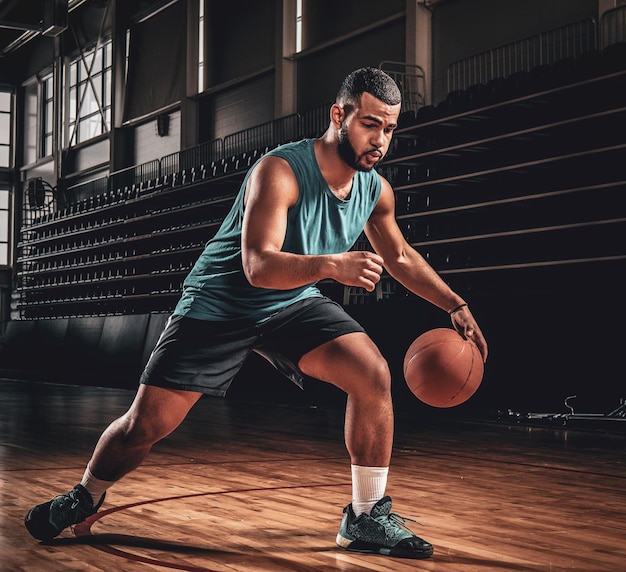 Professional basketball player in an action in basketball field.