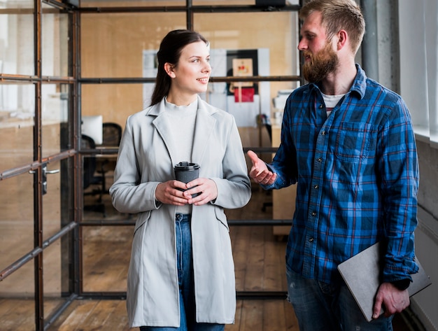 Free photo professional businesspeople discussing something at workplace